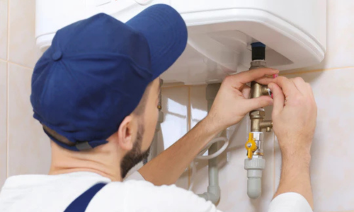 A plumber working underneath a sink