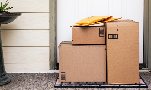 Cardboard boxes delivered at the steps of a door